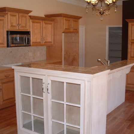 oak kitchen cabinets with and white glass cabinet on the end